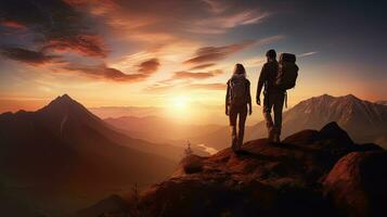 Hiking couple admiring the sunset from a hill top. silhouette concept photo