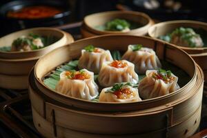 a bamboo plate of dumplings with sauce and garnish photo