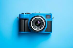 Vintage film camera on blue background. Top view with copy space photo