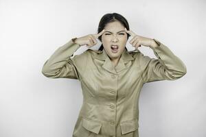 Mad civil worker woman wearing a brown uniform feeling so stressed. Indonesian government employees overworked concept. photo