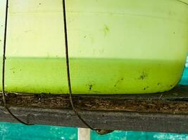 Green water blooms in the sun. Small green microorganisms multiply rapidly in the sun in a container of water. photo