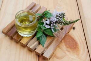 a glass of tea from boiling water from the leaves of cat whiskers or Orthosiphon aristatus. a drink that can be used as a traditional herbal medicine to treat diabetes photo