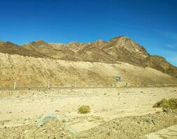 Road going through Sinai mountains, hills and desert photo