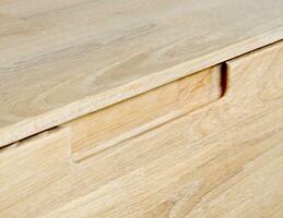 Drawers close view photo, wooden furniture elements background. Furniture details photo