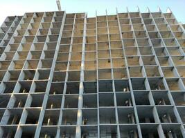 Building construction photo, new building isolated over blue sky background photo