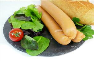 Tasty sausages and vegetables, food photography photo