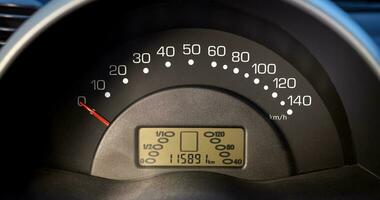 Car speedometer and sensors on a control panel background, car elements close view photo