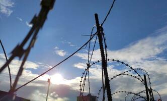 Barbed wire fence, prison and freedom conceptual background photo