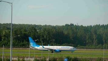 SAINT PETERSBURG, RUSSIA JULY 26, 2022 - Boeing 737 of Pobeda Airlines set speed for departure at Pulkovo airport, side view long shot. Tourism and travel concept video