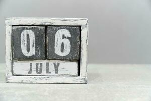 Calendar for July 06, made of wooden cubes, on gray background.With an empty space for your text.Hiroshima Day. photo