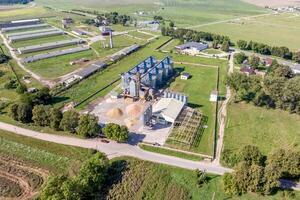 aerial panoramic view on agro-industrial complex with silos and grain drying line for drying cleaning and storage of cereal crops photo