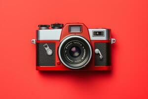 Retro camera isolated on red background. Flat lay, top view photo