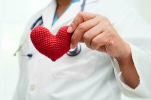 doctora asiática con corazón rojo para la salud en el hospital. foto