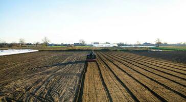 Kherson oblast, Ukraine - November 12, 2021 Land cultivation on the field by tractor. Farming. Agriculture agribusiness. Milling ground from old crops. Softening and improving soil qualities. photo