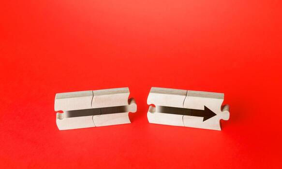 Divided puzzles with an arrow. Continuation of process, further progress. Moving forward, direction. Ensuring growth and expansion. Establishing a process from combination of two components. photo