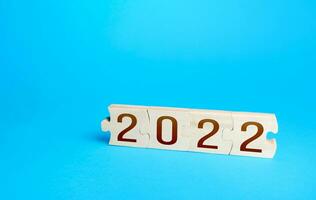 Puzzles and 2022. New Year and Christmas holidays. New opportunities and horizons. Plans and goals. Trends ideas. Summing up, drawing conclusions. Future. Business planning. Analytics, forecasting photo