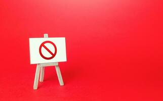 Prohibition sign NO easel on red background. No access, restricted area. Absence of something. Sanction restrictions. Ban, Embargo. Denying, stopping. Reaching Limits. Restrictive measures. Full sale photo