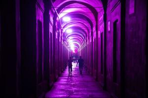 Bologna,Italy- June 23, 2023-People sthis iroll at night under the arcades leading to the sanctuary of San Luca illuminated for the first edition of the Bologna arcades Festival. photo