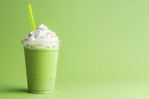 Green tea frappucino with whipped cream in a takeaway cup isolated on green background with copy space. ai generated photo