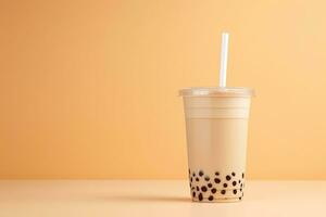 iced milk tea and bubble boba in the plastic glass on the beige background. ai generated photo