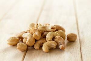 Many Roasted salted cashew nuts  on wooden background photo