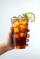 A hand holding takeaway plastic cup of delicious iced lemon tea isolated on white background. ai generated photo