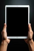 Hand holding tablet with mockup blank screen isolated on black background. ai generated photo