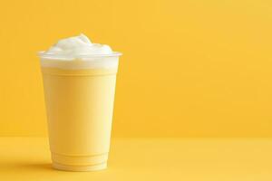 Mango smoothie milkshake in plastic takeaway cup isolated on yellow background with copy space. ai generated photo