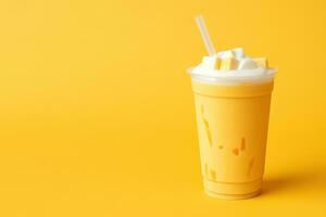 Mango smoothie milkshake in plastic takeaway cup isolated on yellow background with copy space. ai generated photo