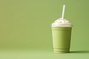 Green tea frappucino with whipped cream in a takeaway cup isolated on green background with copy space. ai generated photo