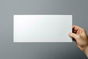 A human hand holding a blank sheet of white paper or card isolated on grey background. ai generated photo
