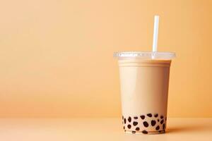 iced milk tea and bubble boba in the plastic glass on the beige background. ai generated photo