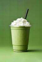 Green tea frappucino with whipped cream in a takeaway cup isolated on green background. ai generated photo