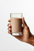 Hand holding a glass of delicious chocolate milk isolated on white background. ai generated photo