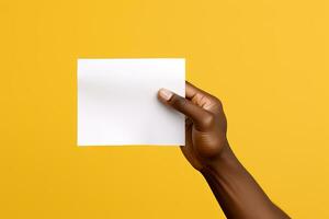 A human hand holding a blank sheet of white paper or card isolated on yellow background. ai generated photo