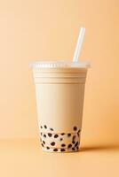 iced milk tea and bubble boba in the plastic glass on the beige background. ai generated photo