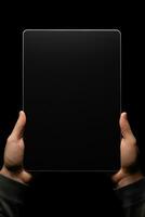 Hand holding tablet with mockup blank screen isolated on black background. ai generated photo