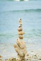 a stack of stones on the beach photo