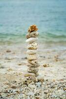 a stack of stones on the beach photo