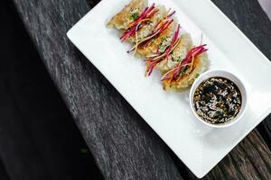 a plate of gyoza on a table photo