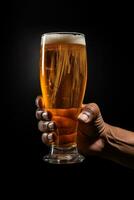 a male hand holding up a glass of beer isolated on a black background. ai generated photo