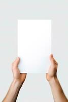 A human hand holding a blank sheet of white paper or card isolated on white background. ai generated photo