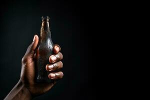 a male hand holding up a bottle of beer isolated on a black background with copy space. ai generated photo