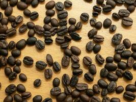 The coffee beans scattered on a wooden floor, suitable for use as a background image. photo