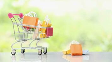 Shopping bags in a shopping cart with natural background. photo
