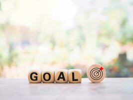 Wooden blocks with the word GOAL and business strategy icons for success and winner concept photo