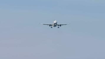 Unrecognizable civil aircraft approaching for landing, view from below. Landing gear extended, aircraft ready for landing. Tourism and travel concept video