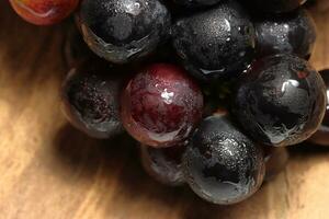 Red grapes on wooden background photo