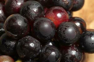 Red grapes on wooden background photo