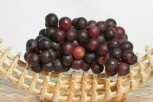 Clusters of ripe grapes on texture background photo